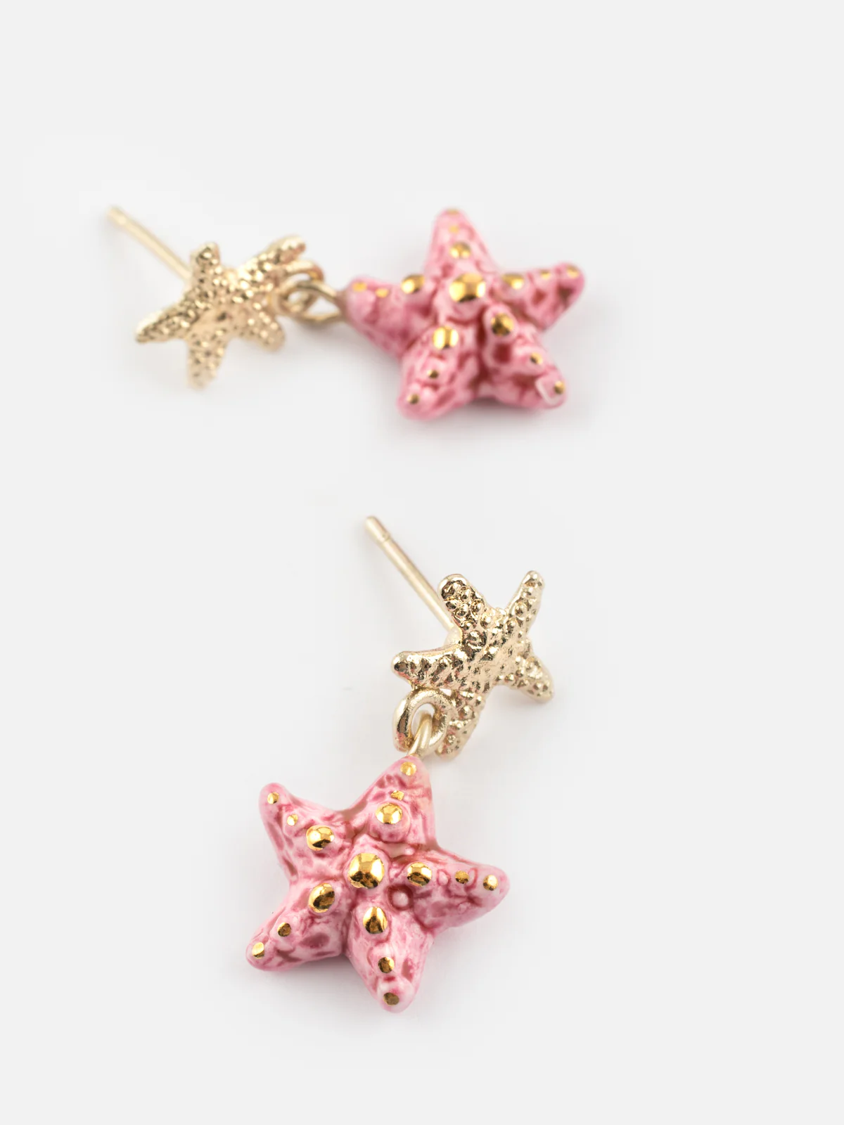 Boucles d'oreilles pendantes étoile de mer rose